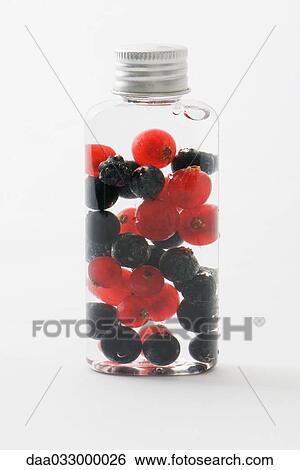 Stock Photograph - Fresh berries in cosmetic bottle. Fotosearch