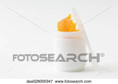 Stock Photo - Fresh orange rind in small cosmetic container. Fotosearch