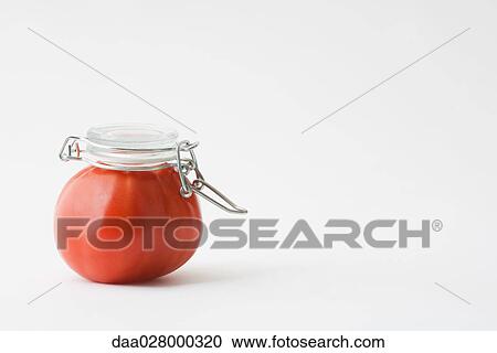 Fresh tomato with canning lid on top of it View Large Photo Image Stock Image - Fresh tomato with canning lid on top of it. Fotosearch