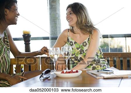 Friends having drinks together View Large Photo Image Stock Image - Friends having drinks together. Fotosearch
