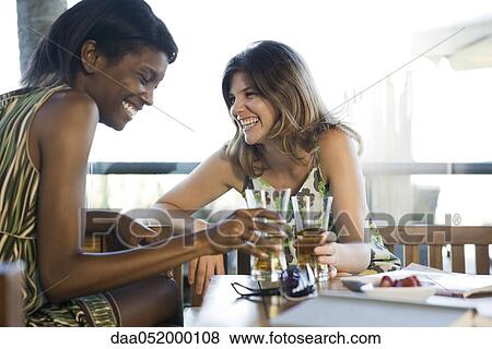 Stock Photo - Friends having drinks together. Fotosearch
