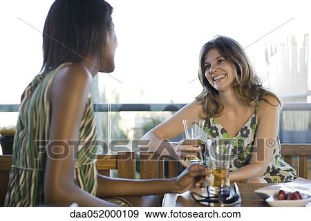 Friends having drinks together View Large Photo Image Stock Photo - Friends having drinks together. Fotosearch