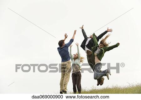 Friends jumping on meadow View Large Photo Image Stock Image - Friends jumping on meadow. Fotosearch