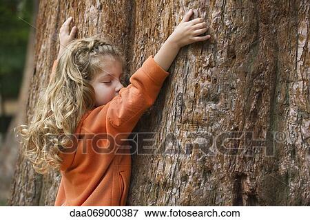 Stock Photo - Girl embracing tree. Fotosearch