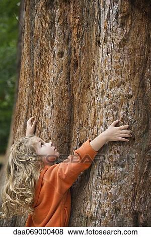 Stock Photo - Girl embracing tree. Fotosearch