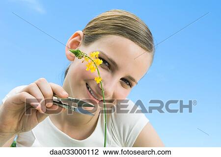 Girl pretending that she is going to cut a long stemmed flower View Large Photo Image Stock Image - Girl pretending that she is going to cut a long stemmed flower. Fotosearch