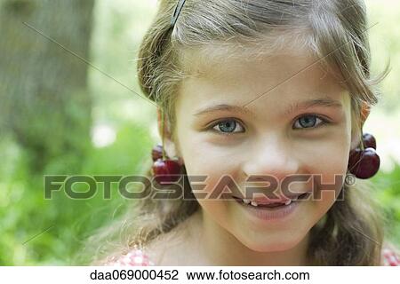 Girl with cherries dangling from her ears, portrait View Large Photo Image Stock Image - Girl with cherries dangling from her ears, portrait. Fotosearch