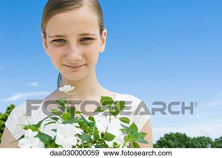 Stock Photo - Girl with impatiens. Fotosearch