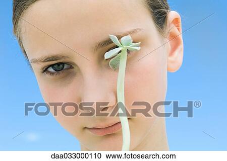 Girl with long stemmed succulent plant obscuring one of her eyes View Large Photo Image Stock Image - Girl with long stemmed succulent plant obscuring one of her eyes. Fotosearch
