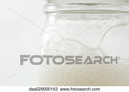 Glass jar with soap suds, extreme close-up View Large Photo Image Stock Image - Glass jar with soap suds, extreme close-up. Fotosearch