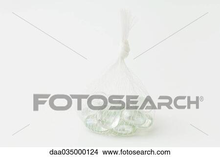 Glass pebbles in a mesh bag View Large Photo Image Picture - Glass pebbles in a mesh bag. Fotosearch