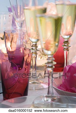 Glasses of champagne on set table View Large Photo Image Stock Image - Glasses of champagne on set table. Fotosearch