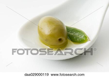 Green olive in spoon View Large Photo Image Stock Photo - Green olive in spoon. Fotosearch