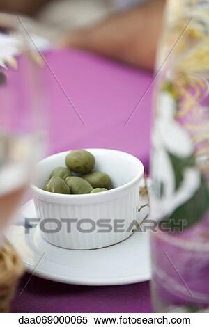 Green olives in ramekin on picnic table outdoors View Large Photo Image Stock Photography - Green olives in ramekin on picnic table outdoors. Fotosearch