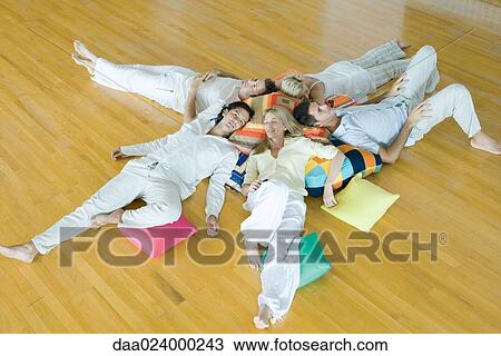 Group of adults lying on floor with cushions, high angle view View Large Photo Image Stock Image - Group of adults lying on floor with cushions, high angle view. Fotosearch