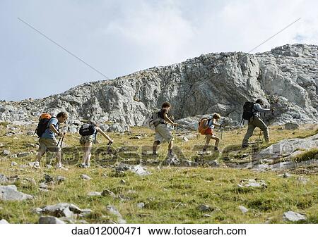 Group of hikers walking through rocky landscape View Large Photo Image Stock Image - Group of hikers walking through rocky landscape. Fotosearch
