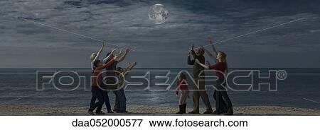 Group of people reaching for the moon View Large Photo Image Stock Photo - Group of people reaching for the moon. Fotosearch