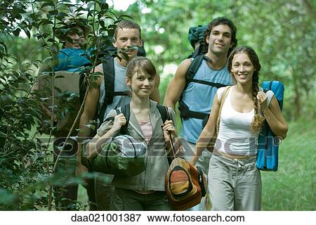 Stock Photo - Group of wilderness campers carrying equipment. Fotosearch