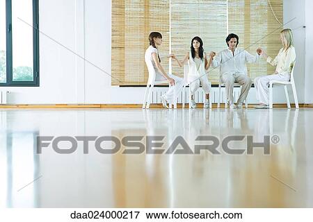 Group therapy, adults sitting in chairs, holding hands View Large Photo Image Stock Photo - Group therapy, adults sitting in chairs, holding hands. Fotosearch