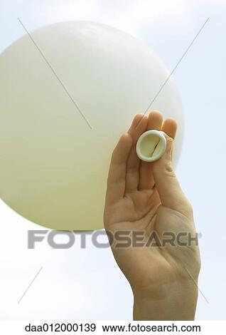 Stock Photo - Hand holding up balloon. Fotosearch