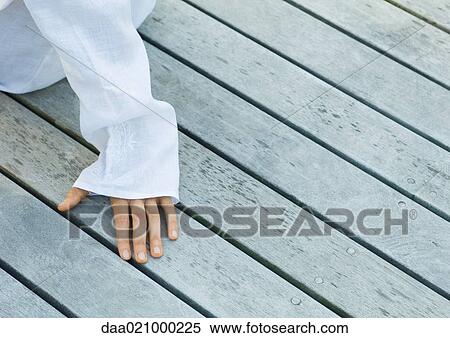 Hand on decking, cropped view View Large Photo Image Stock Photography - Hand on decking, cropped view. Fotosearch