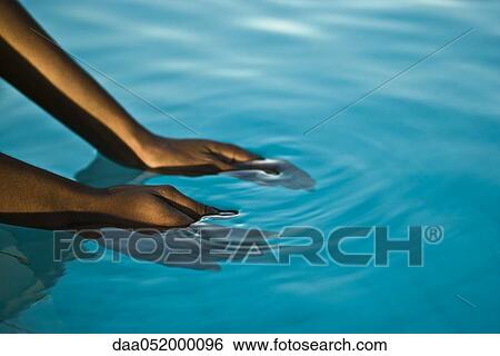 Hands in blue water View Large Photo Image Stock Photograph - Hands in blue water. Fotosearch
