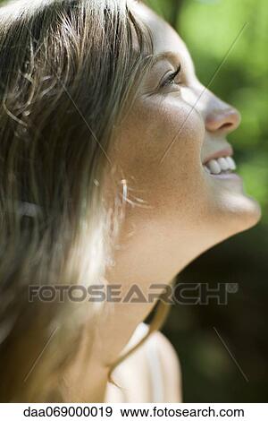 Happy young woman, side view View Large Photo Image Stock Photo - Happy young woman, side view. Fotosearch