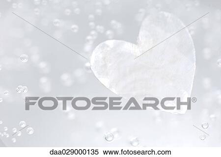Stock Photography - Heart shape and bubbles in water, close-up. Fotosearch