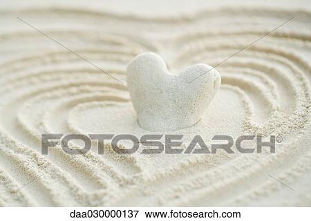 Heart shaped coral stuck in sand, close-up View Large Photo Image Stock Photo - Heart shaped coral stuck in sand, close-up. Fotosearch