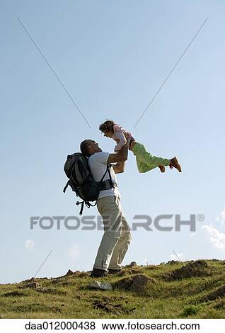 Hiker picking up daughter View Large Photo Image Stock Photo - Hiker picking up daughter. Fotosearch