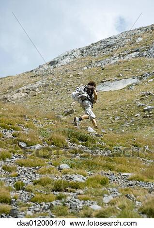 Hiker running uphill View Large Photo Image Stock Image - Hiker running uphill. Fotosearch