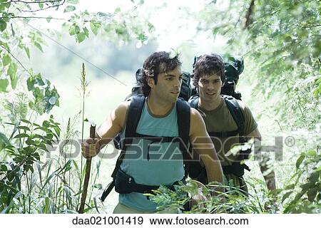 Stock Photo - Hikers entering wooded area. Fotosearch