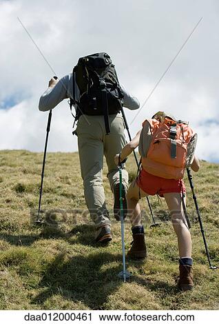 Stock Image - Hikers going uphill, rear view. Fotosearch