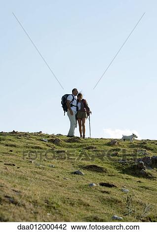 Hikers in mountainous landscape View Large Photo Image Stock Image - Hikers in mountainous landscape. Fotosearch
