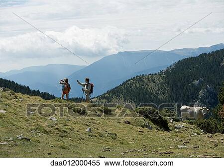 Hikers in mountainous landscape View Large Photo Image Stock Photography - Hikers in mountainous landscape. Fotosearch