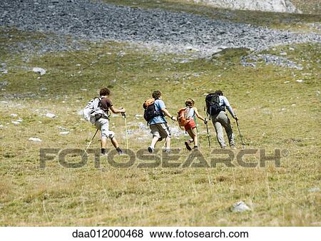 Hikers on mountainous landscape View Large Photo Image Stock Photo - Hikers on mountainous landscape. Fotosearch