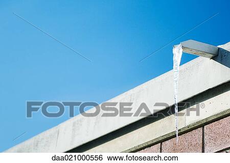 Icicle hanging from gutter View Large Photo Image Stock Photograph - Icicle hanging from gutter. Fotosearch