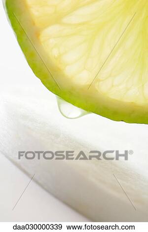 Juicy lime slice and cotton cosmetic pad, close-up View Large Photo Image Stock Photo - Juicy lime slice and cotton cosmetic pad, close-up. Fotosearch