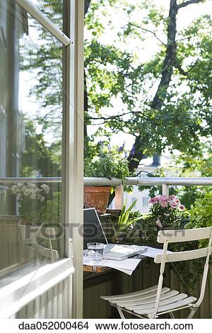 Picture - Laptop computer on patio table. Fotosearch