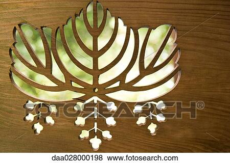 Leaf patterns cut out of wood, close-up View Large Photo Image Stock Photo - Leaf patterns cut out of wood, close-up. Fotosearch