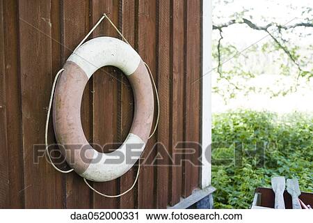 Life belt hanging on wall View Large Photo Image Stock Image - Life belt hanging on wall. Fotosearch