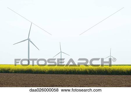 Line of wind turbines in field View Large Photo Image Stock Photo - Line of wind turbines in field. Fotosearch