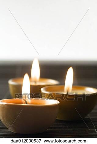 Stock Photo - Lit candles. Fotosearch