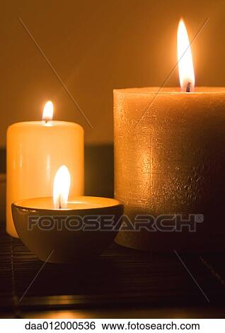 Lit candles View Large Photo Image Stock Photograph - Lit candles. Fotosearch