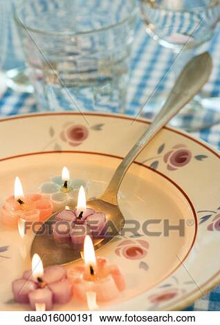 Lit flower-shaped candles in soup plate, with spoon View Large Photo Image Stock Image - Lit flower-shaped candles in soup plate, with spoon. Fotosearch