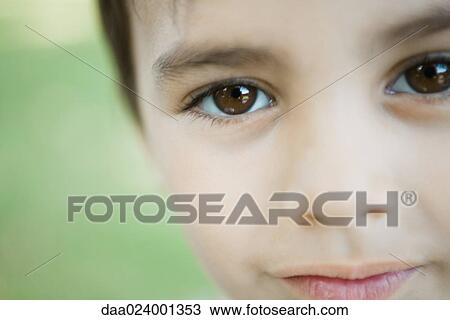 Little boy looking at camera, cropped view of face, close-up View Large Photo Image Stock Image - Little boy looking at camera, cropped view of face, close-up. Fotosearch