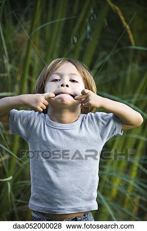 Little boy making faces, portrait View Large Photo Image Stock Photo - Little boy making faces, portrait. Fotosearch
