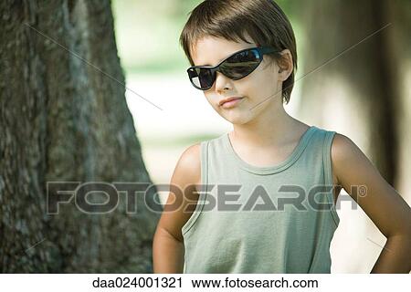 Little boy outdoors, wearing sunglasses View Large Photo Image Stock Image - Little boy outdoors, wearing sunglasses. Fotosearch