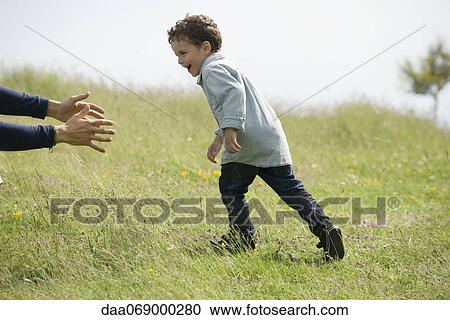 Little boy running toward adult's arms View Large Photo Image Stock Image - Little boy running toward adult's arms. Fotosearch