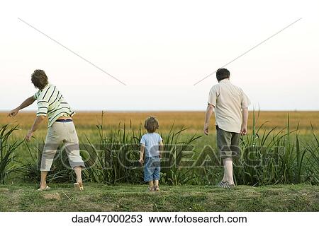 Little boy with father and grandfather walking in field View Large Photo Image Stock Image - Little boy with father and grandfather walking in field. Fotosearch